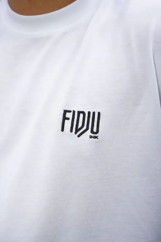 Close-up of the embroidered FIDJU INK logo on the chest.